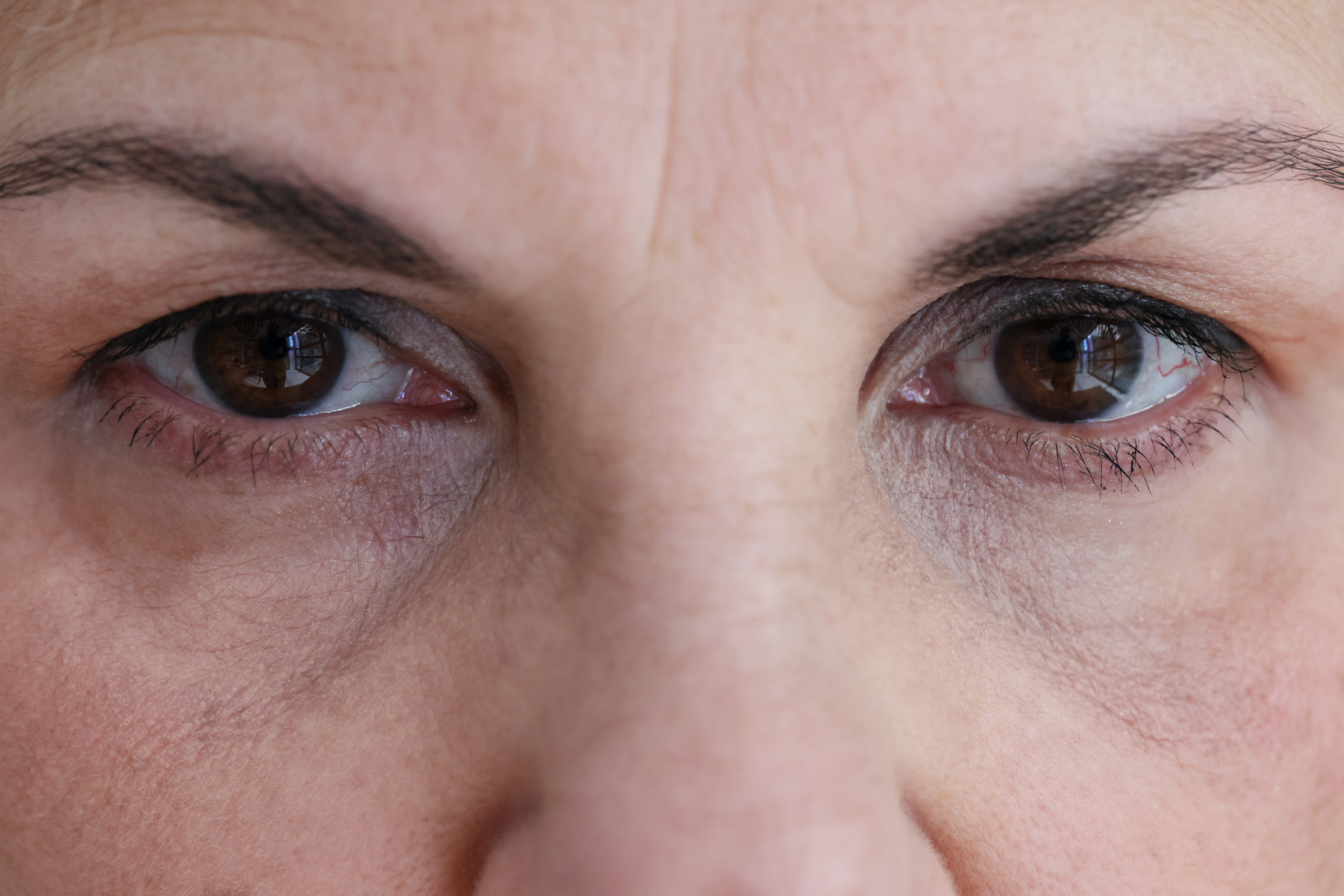 Senior Woman Face with Dark Brown Eyes and Wrinkles